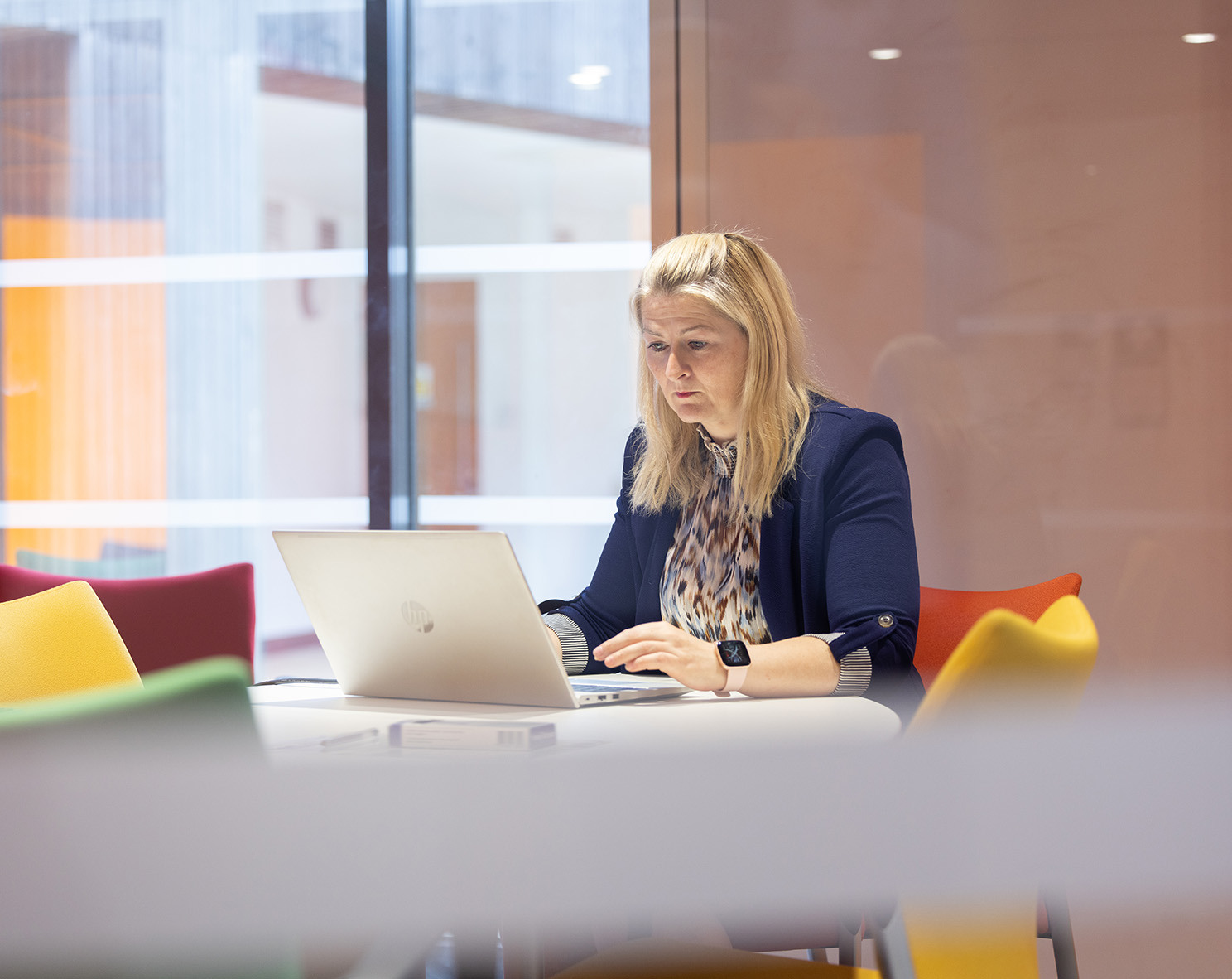 Female professional sat at desk in front of laptop