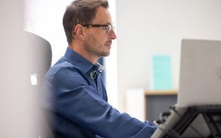 Side view of a man sat at desk